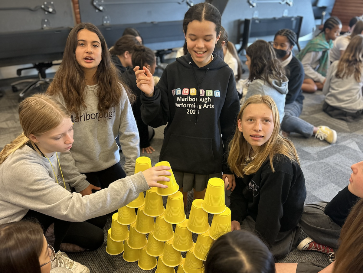 7th grade students build cup towers during PALs class meeting.